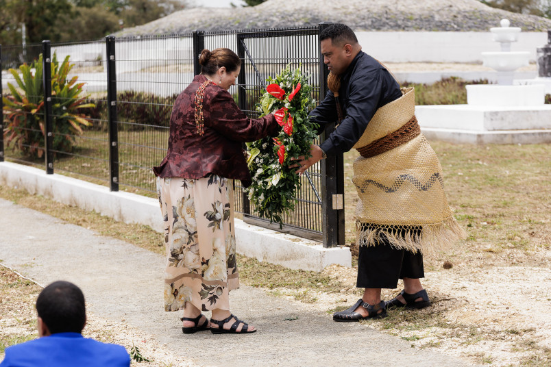 Dame Cindy presenting a wreath to be laid