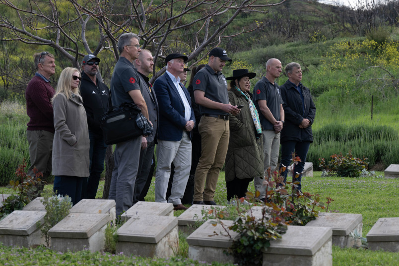 Dame Cindy, Dr Davies and the official party sing a waiata at the No. 2 Outpost Cemetery