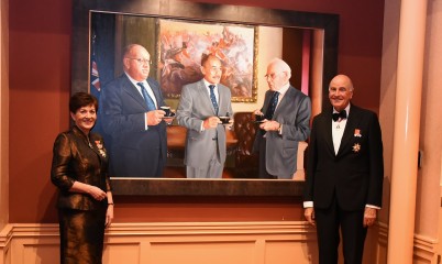 image of Dame Patsy and Sir David with a portrait of previous Governors-General