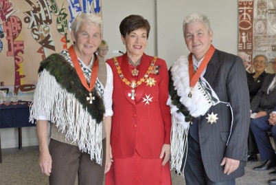 Dame Jools and Dame Lynda Topp wearing the korowai received by Dames