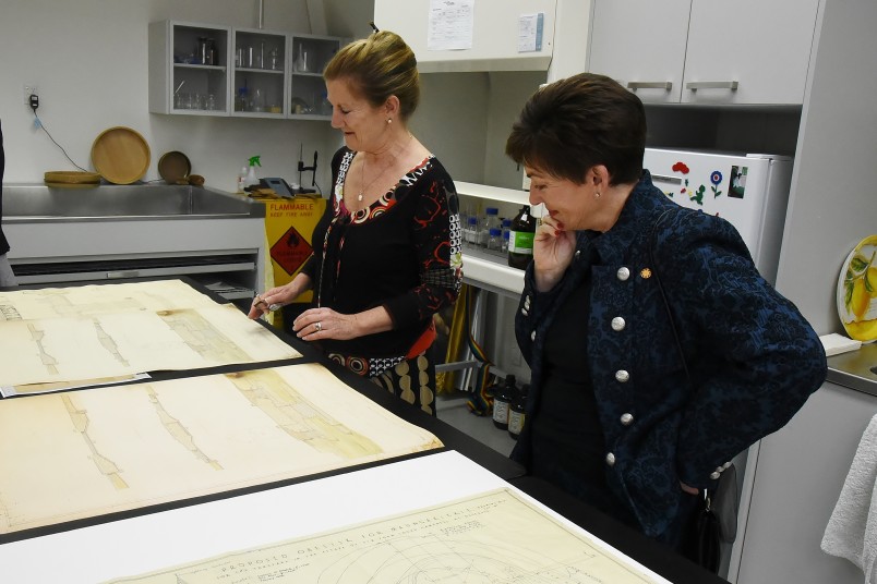Image of Paper Conservator Camilla Baskcomb talking Dame Patsy through the conservation process for a collection of early 20th century architectural drawings