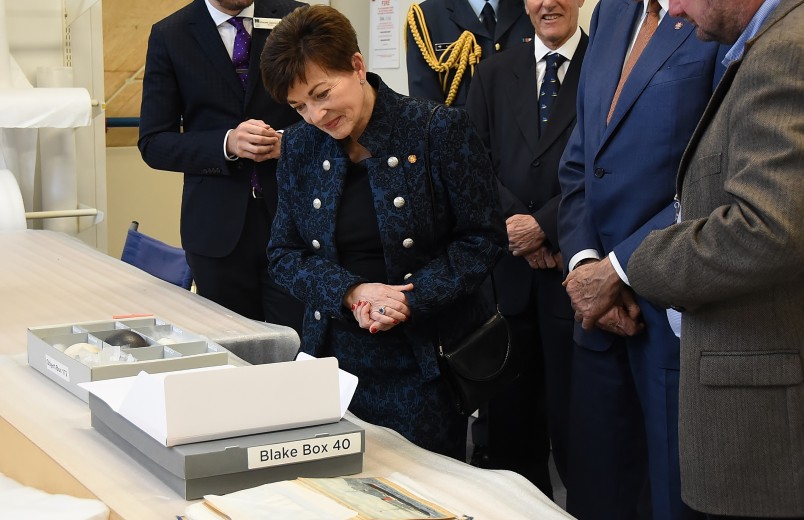 Image of Dame Patsy looking at papers from the Sir Peter Blake archive