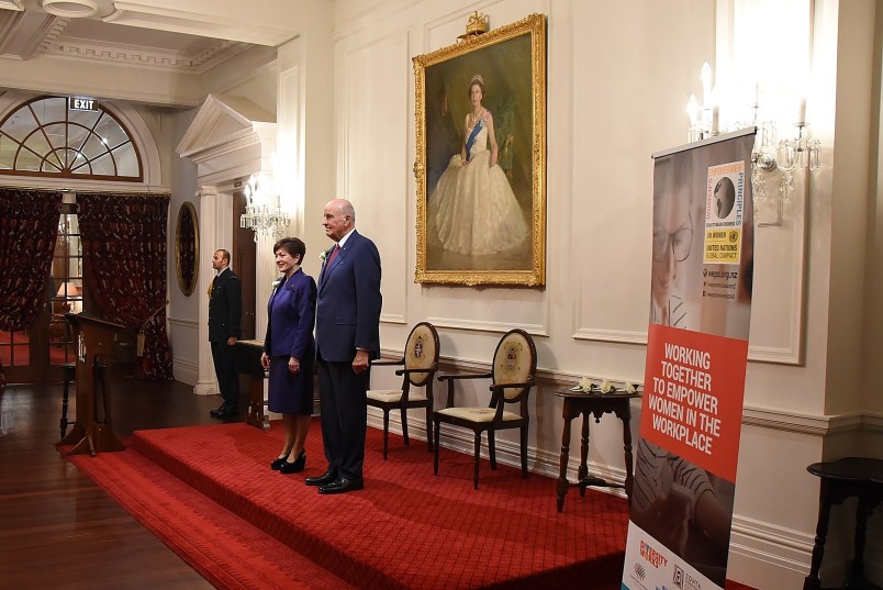 Image of Dame Patsy and Sir David standing for 'God Save the Queen' 