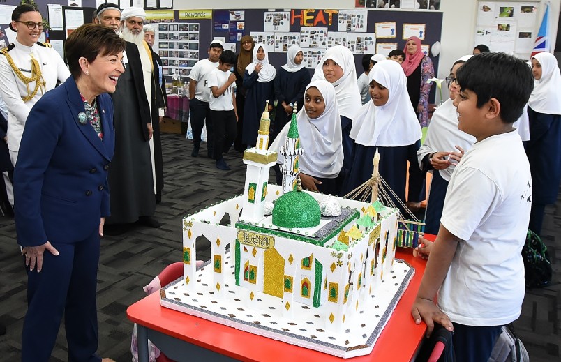 Image of Dame Patsy checking out a model of a mosque built by students
