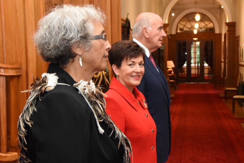 Image of Dame Patsy and Sir David with kuia Te Ripowhai Higgins waiting for the arrival of the King and Queen of Tonga