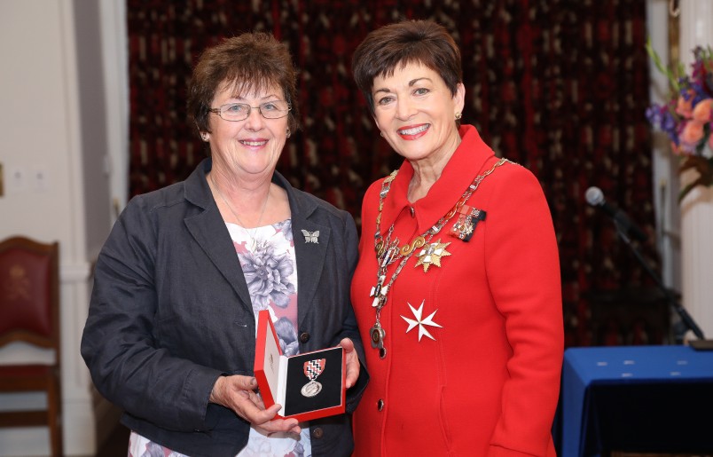 Image of Mary Butler accepting a QSM on behalf of The late Mr Rod Eatwell 