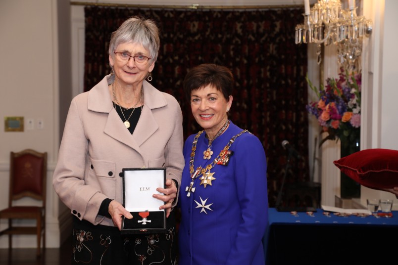 Image of  Josie Snook accepting the insignia on behalf of the late Professor Emeritus Ivan Snook, MNZM, for services to education