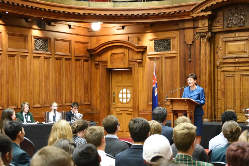 Image of Dame Patsy as Patron of the New Zealand School's Debating Council, addressing the audience
