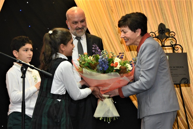 Dame Patsy receiving flowers at Iqra Elementary School