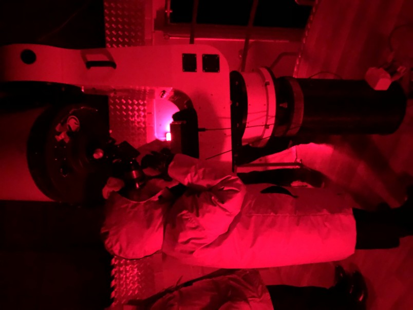 Image of Dame Patsy looking at Saturn through a telescope