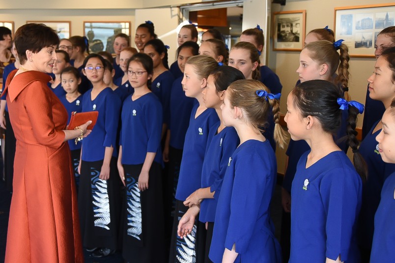 Image of Dame Patsy talking with members of the Auckland Girls' Choir
