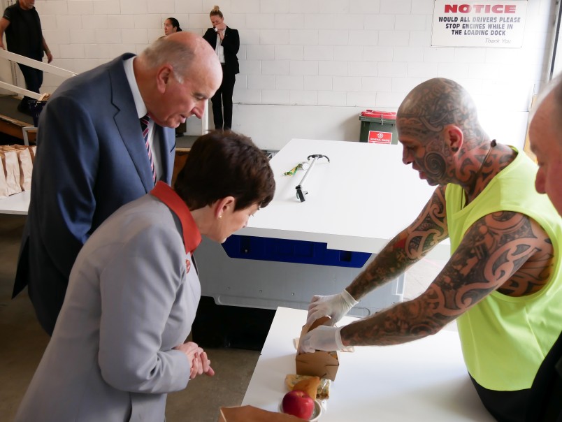 Image of Dame Patsy and Sir David Checking out the takeaway meals for ACM clients