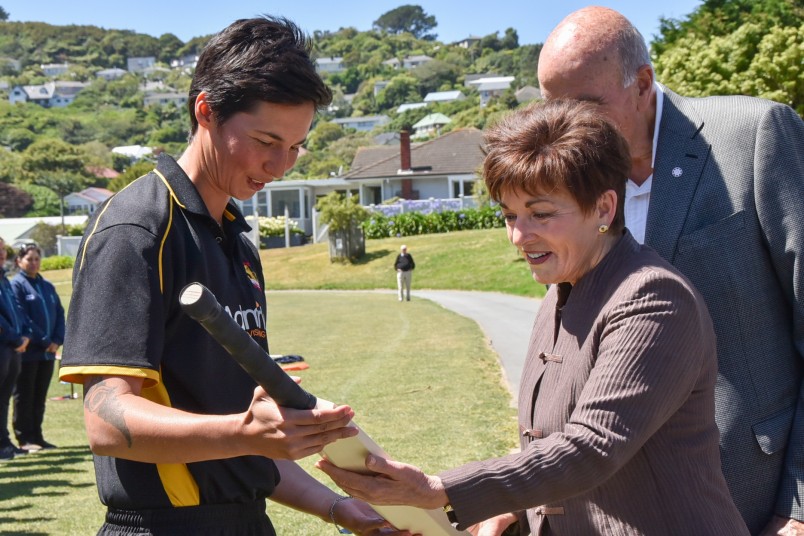 Dame Patsy Reddy being presented with a cricket bat