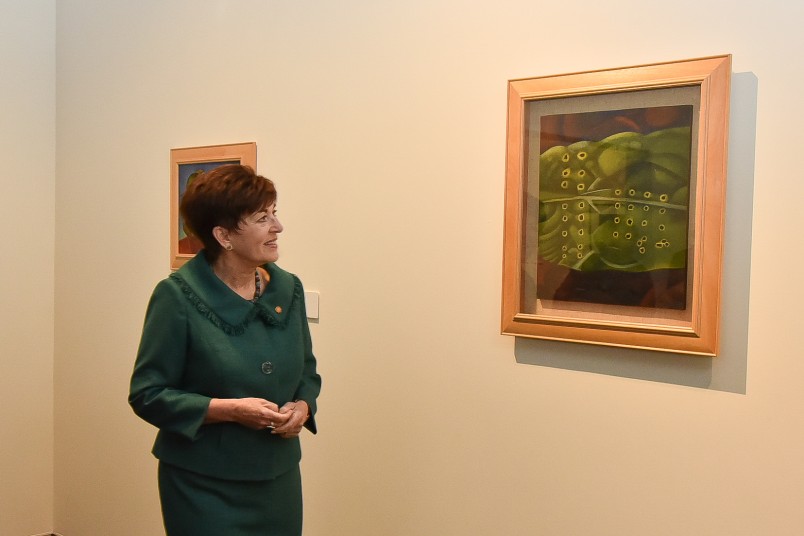 Dame Patsy with a Rita Angus painting from the John Money Collection