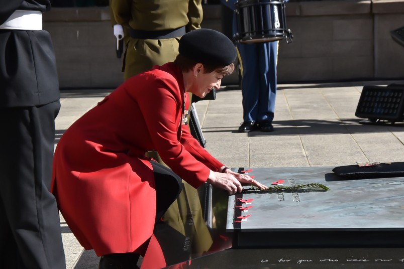Dame Patsy placing a fern on the Tomb of the Unknown Warrior