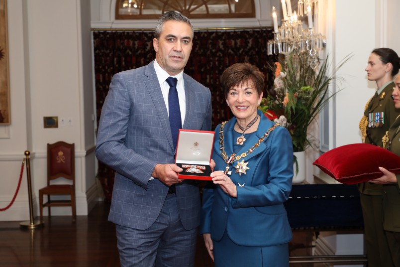 Image of Keving Ransfield accepting the insignia for the late Isobel Ransfield, of Otaki, QSM, for services to Māori