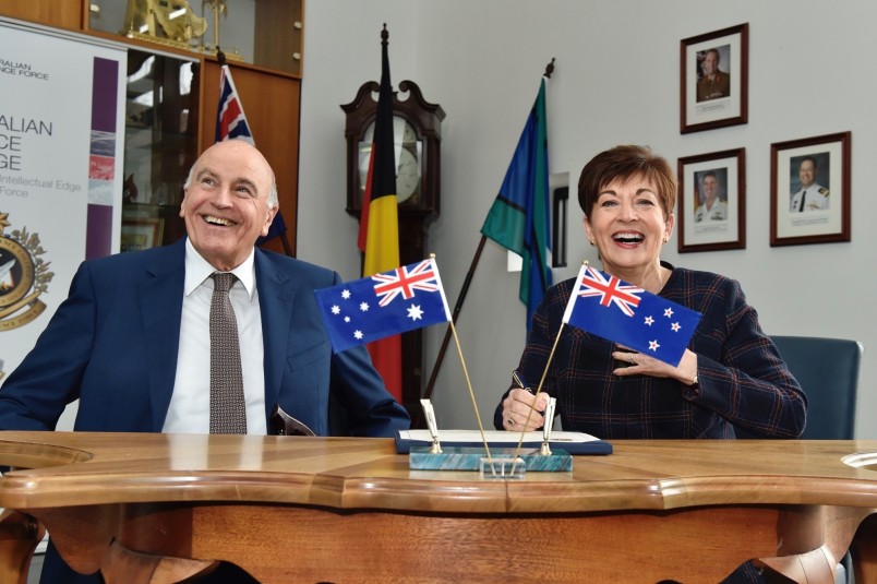 Image of Dame Patsy and Sir David signing the Visitor Book at the Australian Defence College