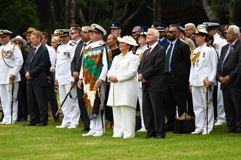 Rear Admiral David Proctor, Dame Cindy, Dr Davis, and guests of honour watching the flag being lowered
