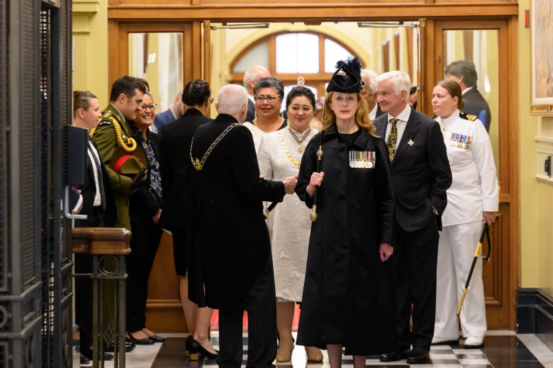 The Black Rod leads the Governor-General across the tiles
