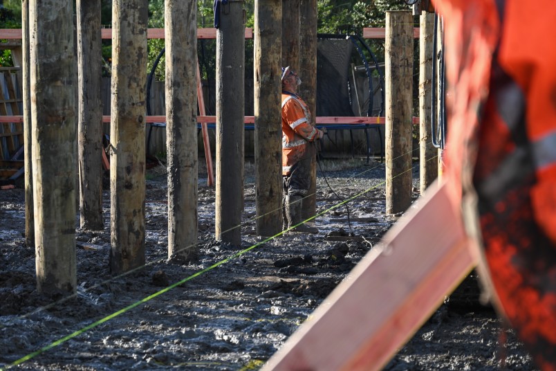 A construction worker supervises the operation of heavy-duty machinery
