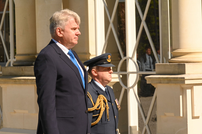 His Excellency Mr Jaan Reinhold, Ambassador of the Republic of Estonia, stands on the dais in front of the Guard of Honour 