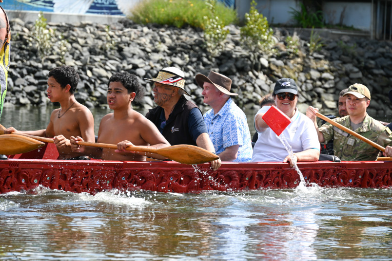 Dame Cindy taking her turn at bailing water from the waka