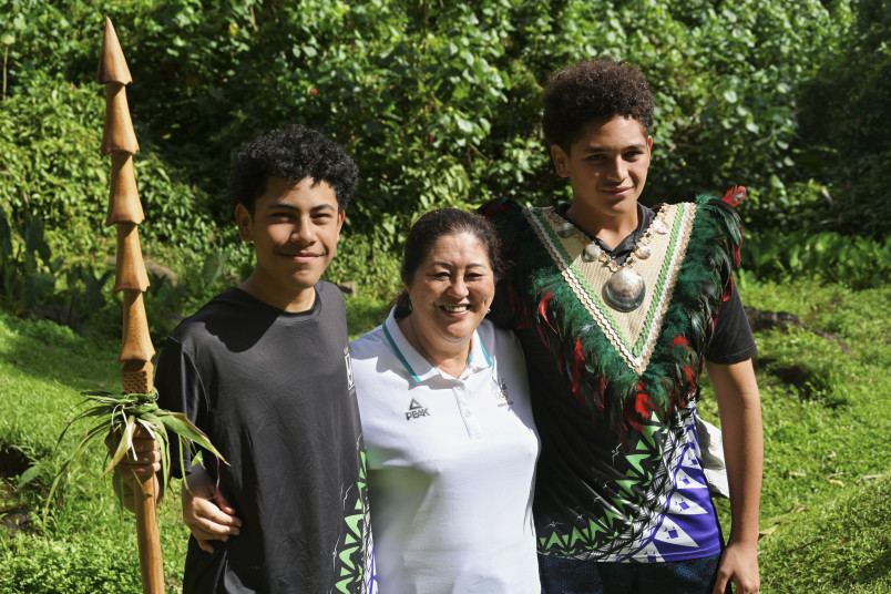 Dame Cindy with two young volunteers