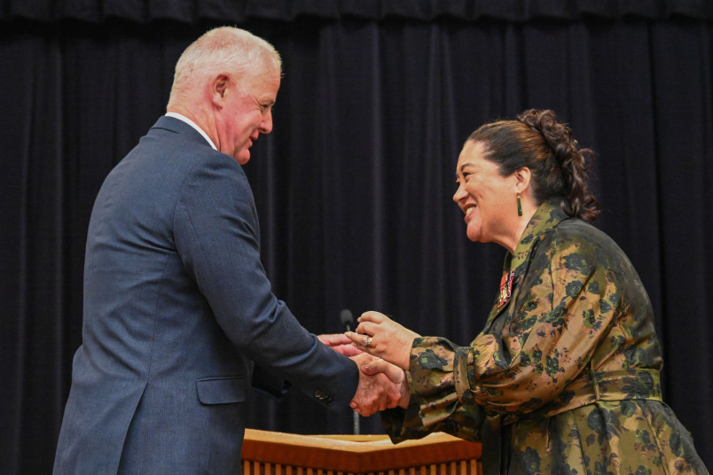College Principal Gary Moore presents Dame Cindy with her lapel pin