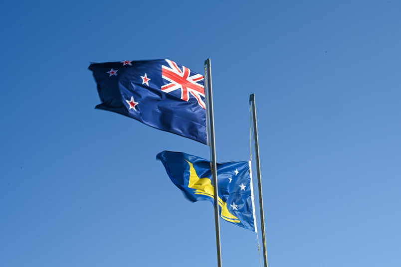 The New Zealand and Tokelauan flags raised