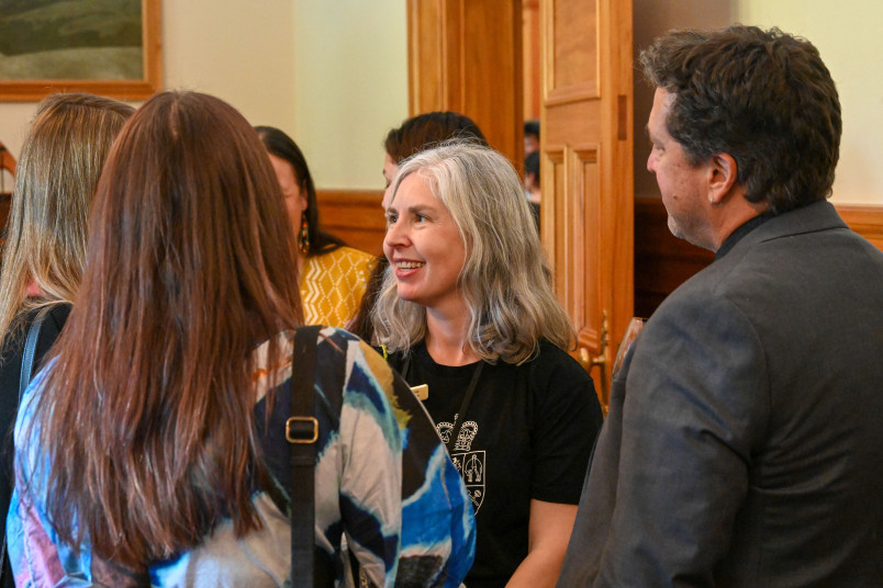Kate, a member of the Government House staff, speaks with guests