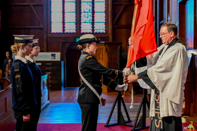 Members of the New Zealand Cadet Forces present the Ensign to The Reverend Lance Lukin