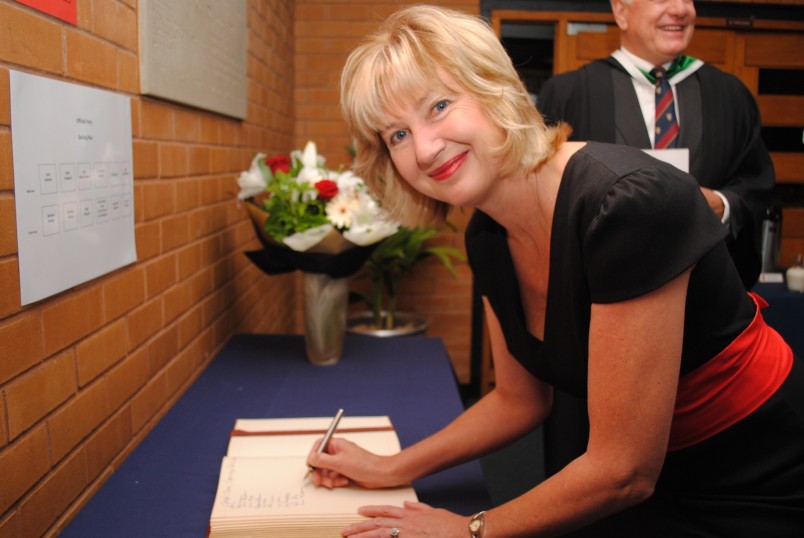 Lady Janine signs the King's College guestbook.