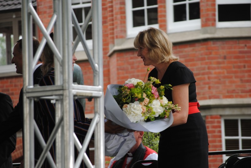 Lady Janine is presented with a floral bouquet.