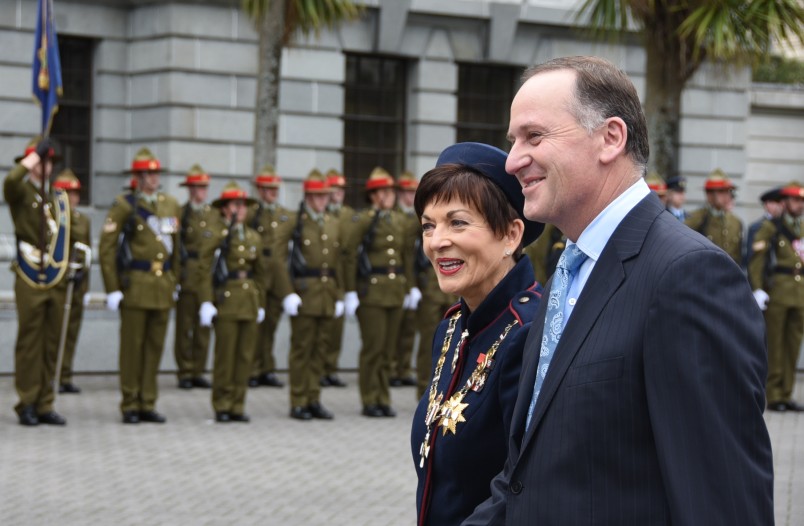 Dame Patsy Reddy is escorted to the dais by Prime Minister John Key.