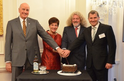 Image of Dame Patsy, Sir David, Mark Stewart and Nigel Watson cutting the cake