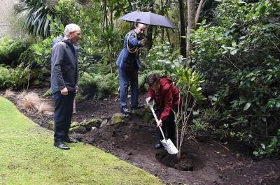 Image of Dame Patsy planting one of the trees