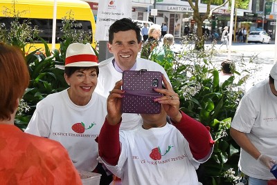 Image of festival volunteer Naina taking a selfie with Dame Patsy and Mayor Justin Lester