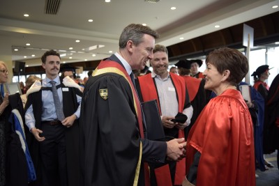 Image of Dame Patsy being congratulated by Pro-Chancellor Neil Paviour-Smith