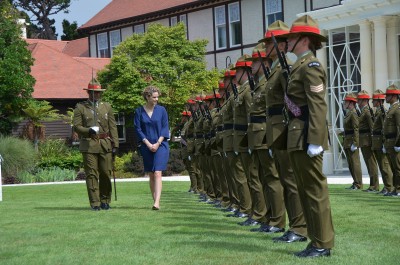 an image of HE Ms Laura Mary Clarke inspecting the guard of honour