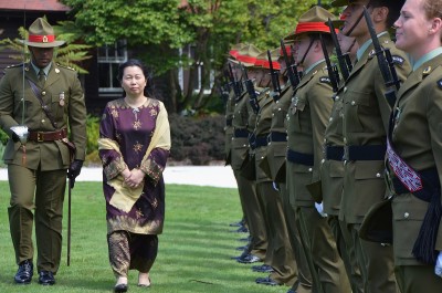an image of HE Ms Nur Izzah Wong Mee Choo inspecting the Guard of Honour