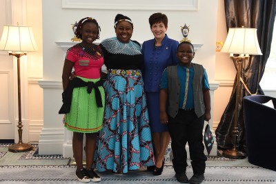 Image of the High Commissioner of the Republic of South Africa, HE Vuyiswa Tulelo and family with Dame Patsy