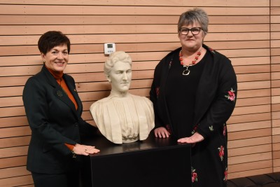 an image of Dame Patsy and Principal Pauline Duthie with a bust of the school's second principal, Helen Connon