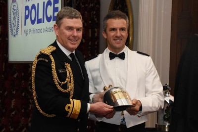 an image of Rear Admiral John Martin accepts a plaque from the Dive Squad