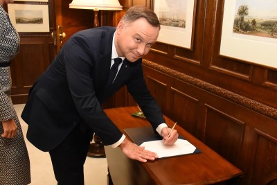 Image of President of the Republic of Poland, HE Andrzej Duda signing the Visitor Book