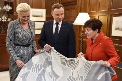 Image of Dame Patsy and the Presidential couple opening the official gifts 