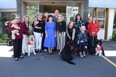 Image of Dame Patsy and the Canine Friends Pet Therapy volunteers and dogs