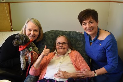 Image of Dame Patsy, Canine Friends volunteer Margaret Ranum and Lainey with Te Hopai resident Suzanne McCrea