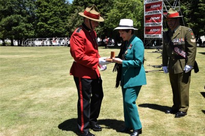 an image of Dame Patsy presenting the Governor-General's medal to Officer Cadet Benjamin Falk
