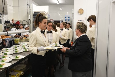 Image of Marion checking the plates before they go out to the guests