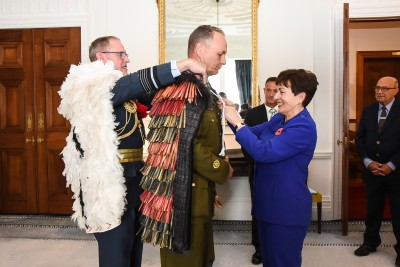 Chief of Defence Air Marshall Kevin Short and Dame Patsy presenting the hieke to WO1 Mark Mortiboy